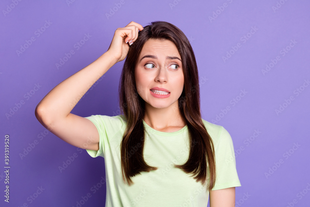 Photo portrait of stressed troubled girl nervous looking at empty space isolated on vivid violet color background Photo portrait of stressed troubled girl nervous looking at empty space isolated on vivid violet color background