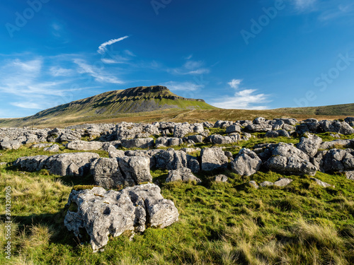 Limestone outcrop next to the mountain of Pen-y-ghent in the Yorkshire Dales National Park. At 2,277 feet, the mountain is one of the 'Three Peaks of Yorkshire'. photo