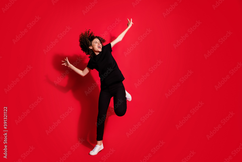 Photo portrait full body view of crazy girl dancing standing on one leg isolated on vivid red colored background Photo portrait full body view of crazy girl dancing standing on one leg isolated on vivid red colored background