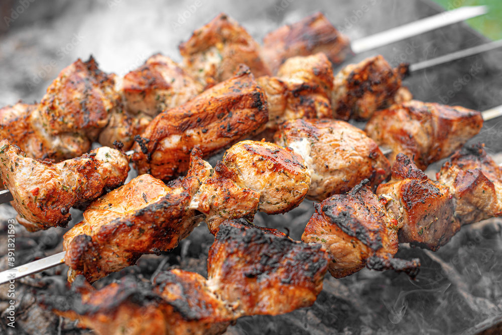 The barbecue is grilled on the grill. Meat or shish kebab on the fire.