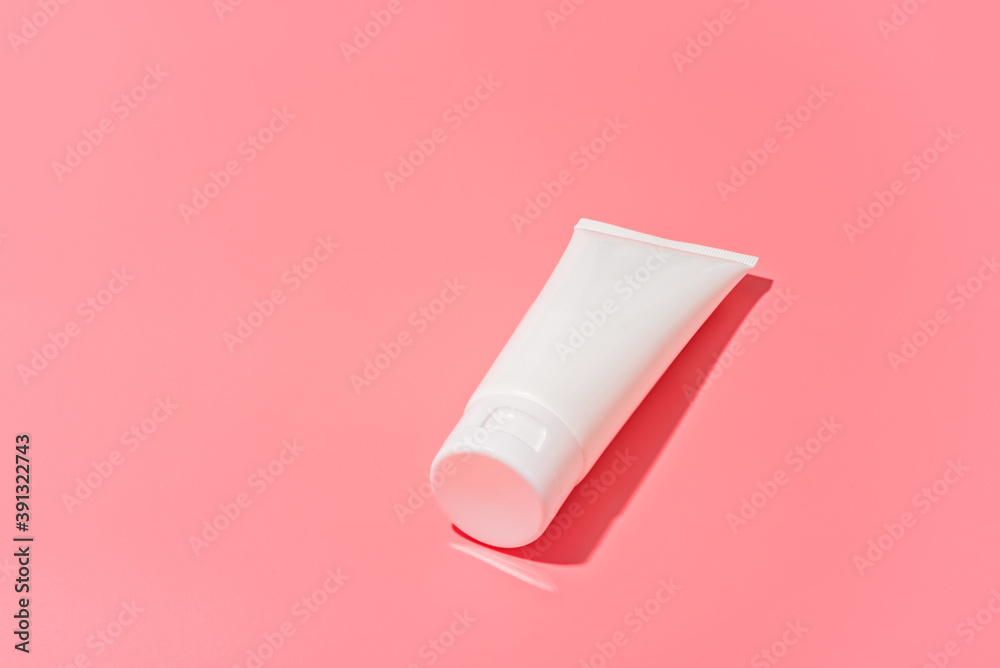 Blank white tube design on a pink background. Mockup Blank white tube design on a pink background. Mockup