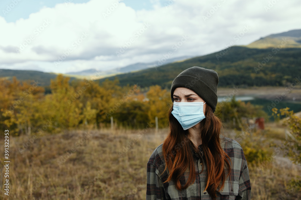 Female portrait medical mask autumn dry grass mountains