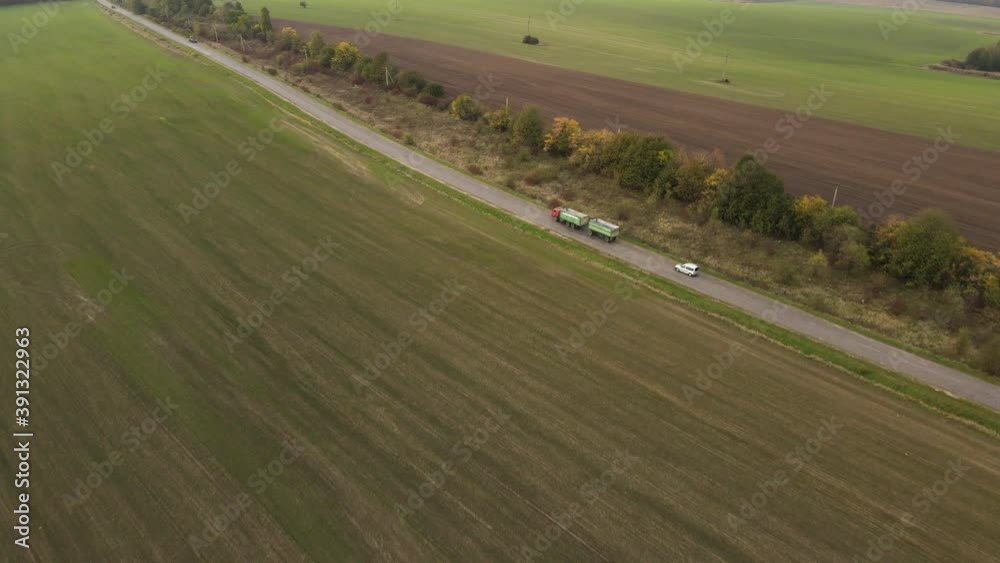 Aerial drone view on road, mooving cars and green field.View on highway, field and trees. Aerial drone view on road, mooving cars and green field.View on highway, field and trees.