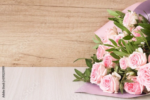 Pink roses on wooden background. Bouquet of pink roses  Floral background image with copy space for text