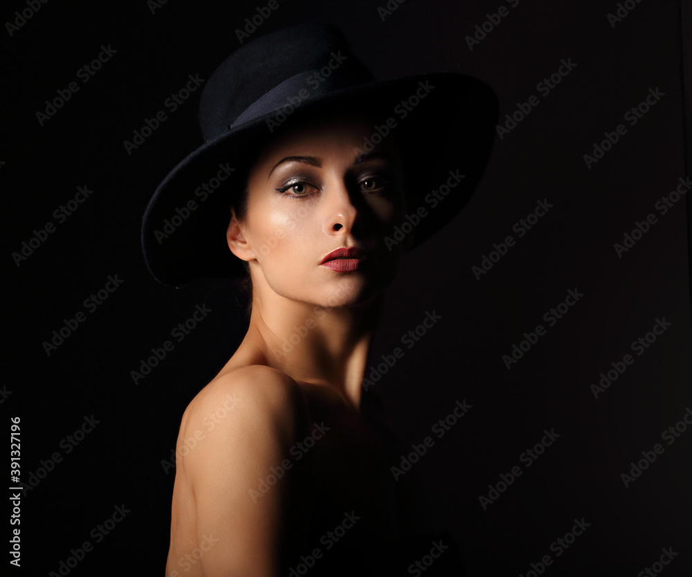 Beautiful makeup woman with elegant healthy neck, nude back and shoulder on black background in fashion hat with empty copy space. Closeup front view portrait. Beautiful makeup woman with elegant healthy neck, nude back and shoulder on black background in fashion hat with empty copy space. Closeup front view portrait.