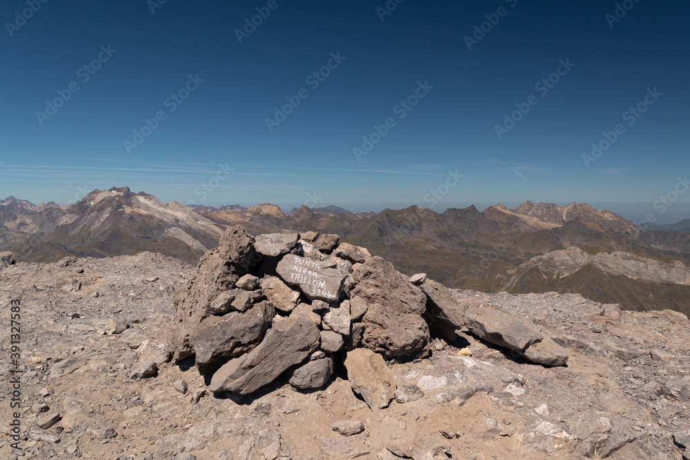 Milestones atop the 3144m Taillon Peak with Vignemale Peak in the background