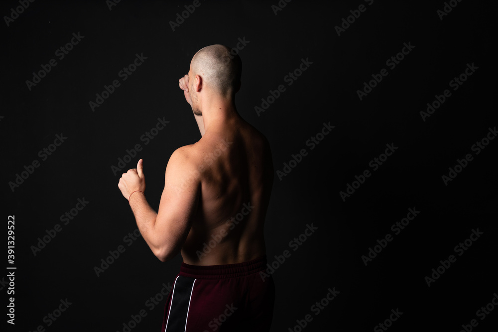 Fototapeta premium Athletic, beautiful strength in training pumps up muscles. Strong bodybuilder, best abs, shoulders, biceps, deltoid and pronator circular.