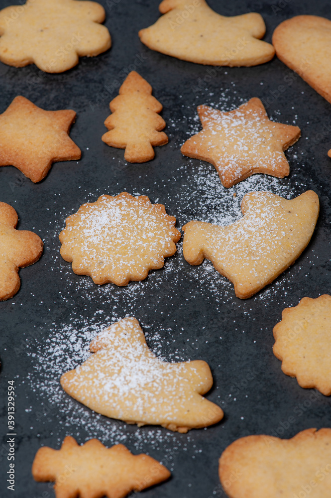 Close-up of delicious homemade Cookies, in preparation for Christmas, displayed on a Slateplate.  Covered with powdered sugar.