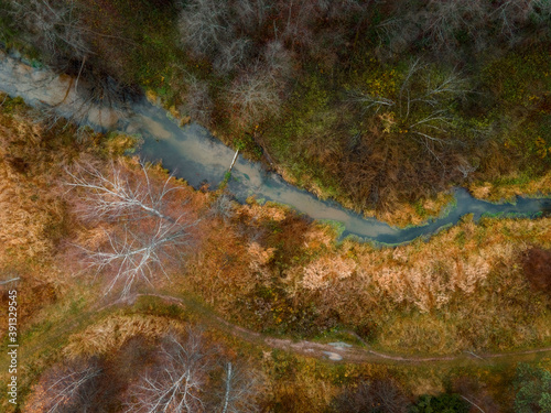 Fototapeta Naklejka Na Ścianę i Meble -  Aerial view of small forest river Skalba in Moscow region, Russia. Beautiful autumn landscape at sunny november day
