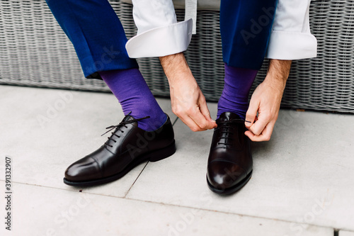 Elegant man have purple socks and wearing black shoes. Gentleman's, men's set © Micha