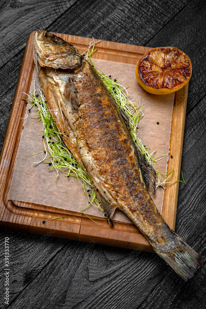 Grilled mullet or trout. Festive table with delicious food. Grilled mullet or trout. Festive table with delicious food.