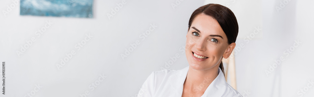 cheerful brunette nurse in white coat smiling at camera, banner cheerful brunette nurse in white coat smiling at camera, banner