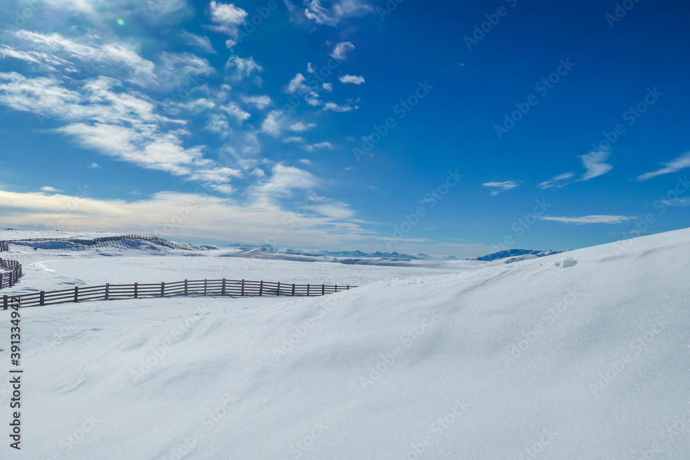 Panoramic view on snow capped Alps in Austria, seen from Katschberg Ski Resort. There is a fence going through the middle of the slope. The slopes are covered with fresh, powder snow. Winter landscape Panoramic view on snow capped Alps in Austria, seen from Katschberg Ski Resort. There is a fence going through the middle of the slope. The slopes are covered with fresh, powder snow. Winter landscape