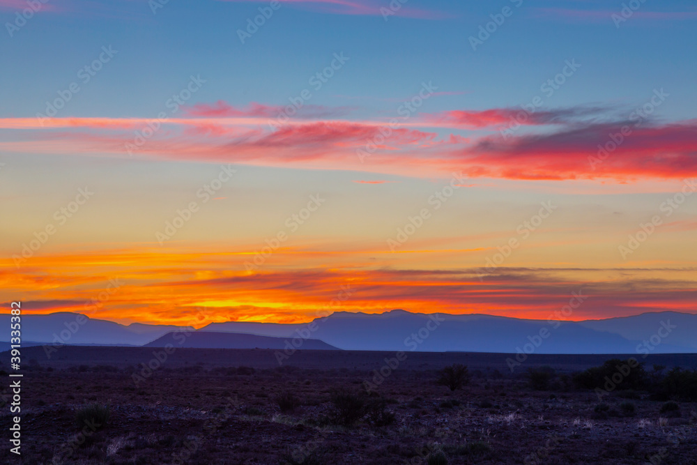 Orange clouds and blue mountains at sunset in the Karoo Orange clouds and blue mountains at sunset in the Karoo