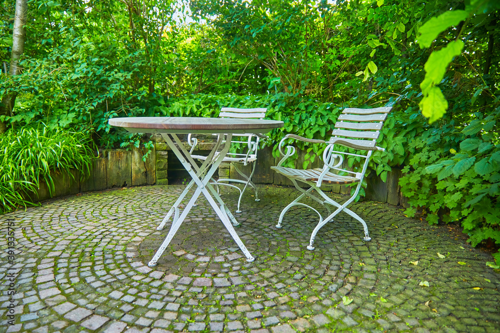 garden chairsRustic garden terrace with garden chairs and table.