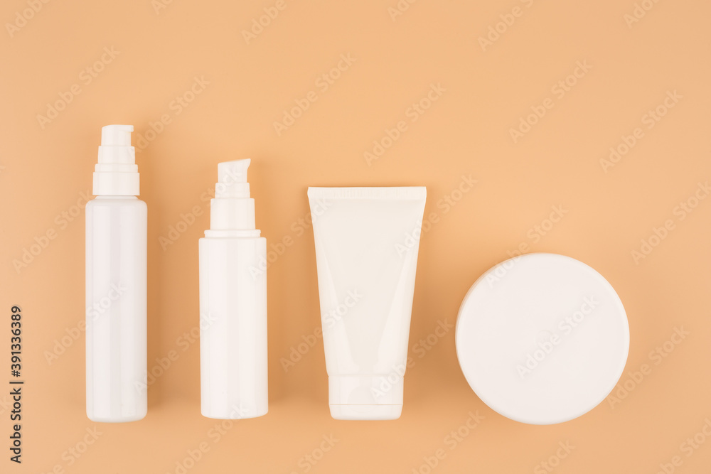 Minimalistic still life with a set of cosmetic products for skin care on bright beige background Minimalistic still life with a set of cosmetic products for skin care on bright beige background