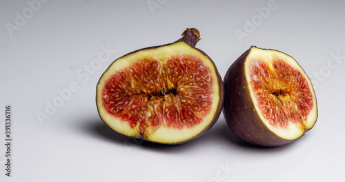 Fresh figs. Fruit with half isolated on grey background.