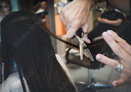 Professional hairdresser cut hair. Haircut close up. Scissor cutting hair. Cutting hair from salon