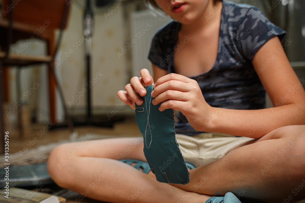 Girl sews a sleep mask from fabric. Handmade hobby