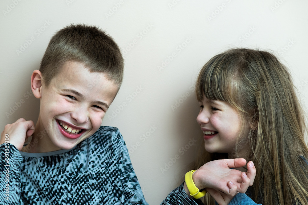 Two children boy and girl fooling around having fun together. Happy childhood concept. Two children boy and girl fooling around having fun together. Happy childhood concept.