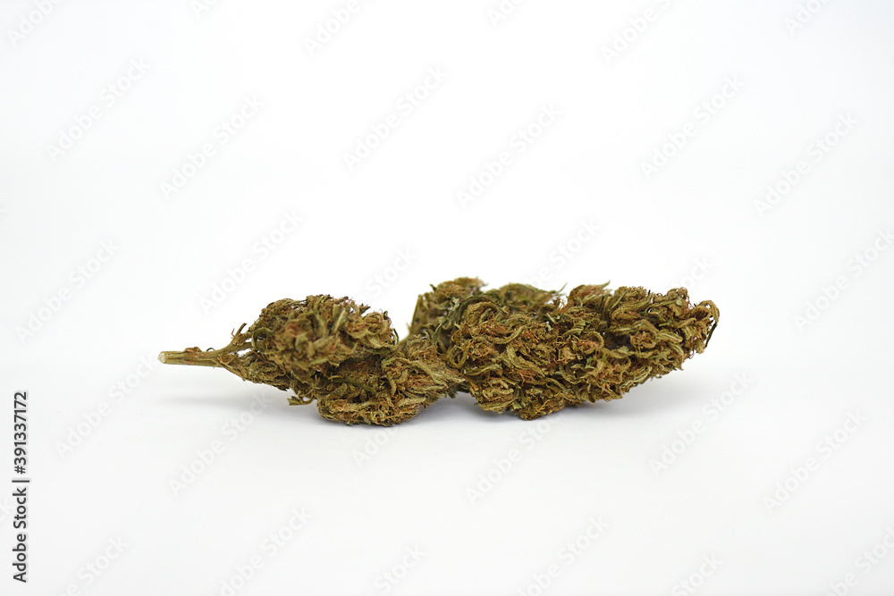 Dry flower of medical marijuana on white bottom, variety Mooje Dry flower of medical marijuana on white bottom, variety Mooje