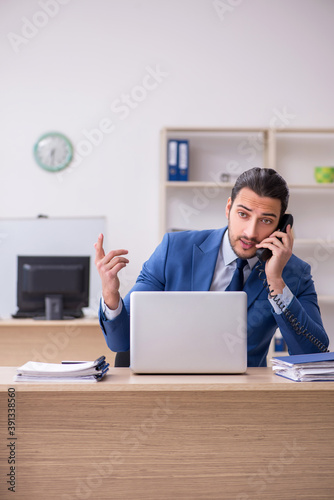 Young male businessman employee working in the office