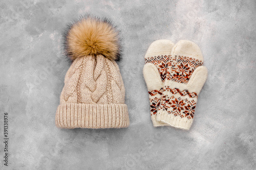 winter clothes mittens and knitted haton a Gray stone background photo