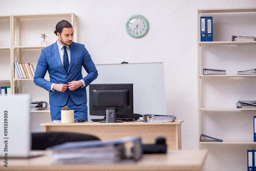 Young male businessman employee working in the office Young male businessman employee working in the office