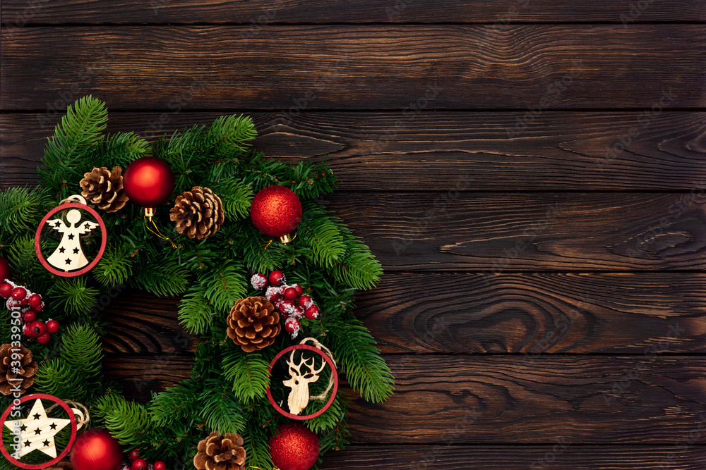 top view of decorative festive wreath with red a christmas toys on dark wooden top view of decorative festive wreath with red a christmas toys on dark wooden