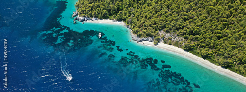 Aerial ultra wide panoramic view of tropical paradise rocky bay visited by sailboats and yachts in Caribbean exotic destination island