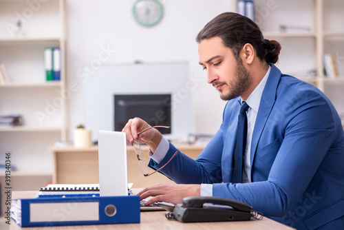 Young male businessman employee working in the office