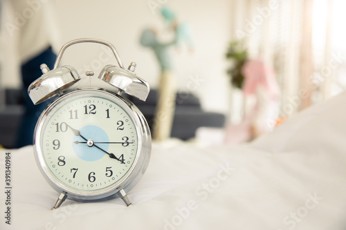 family time with new baby concept, clock with blur mother play with newborn infant at home background.