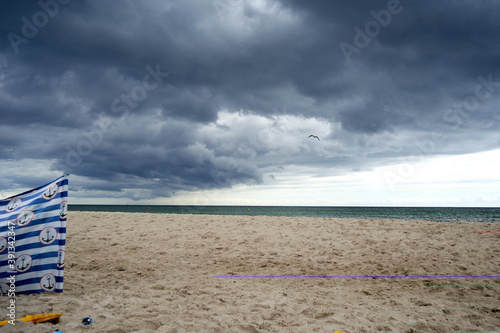 Fototapeta Naklejka Na Ścianę i Meble -  A windbreak, cloudy day at beach , Baltic sea