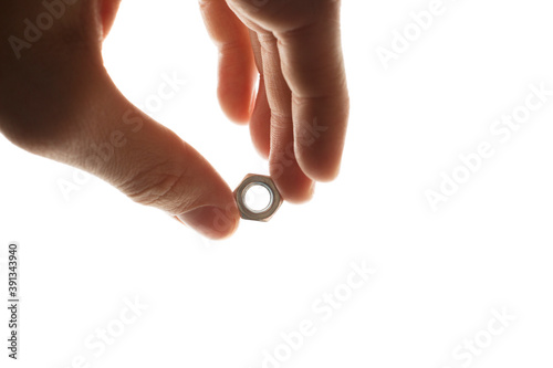 screw-nut in hands on a white background