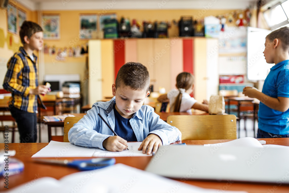 Young boy in elementary school doing test.Educational concept. Young boy in elementary school doing test.Educational concept.
