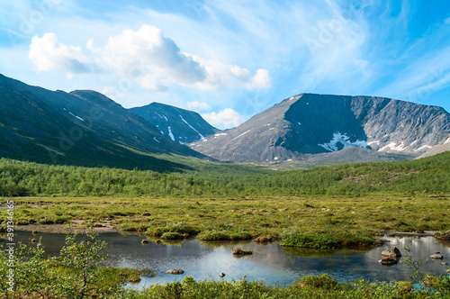 Mountain peaks and tundra at summer season. The Khibiny Massif are the highest mountains of the Kola Peninsula, northern Russia