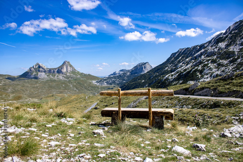 Wooden bench against the backdrop of a mountain landscape. Mountain landscape of Durmitor National Park, Montenegro, Europe, Balkans, Dinaric Alps, UNESCO World Heritage Site.