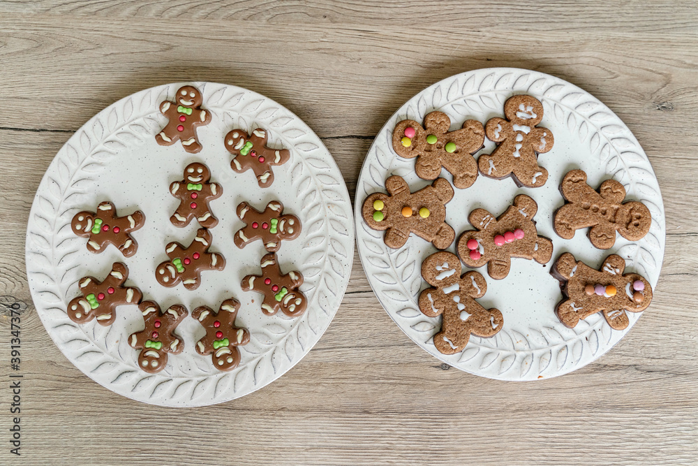 Horizontal view of home made ginger cookies on a plate with sorted colorful sugar decoration. Christmas recipe of traditional desserts for the festivities. Lifestyle with kids in the kitchen. Horizontal view of home made ginger cookies on a plate with sorted colorful sugar decoration. Christmas recipe of traditional desserts for the festivities. Lifestyle with kids in the kitchen.