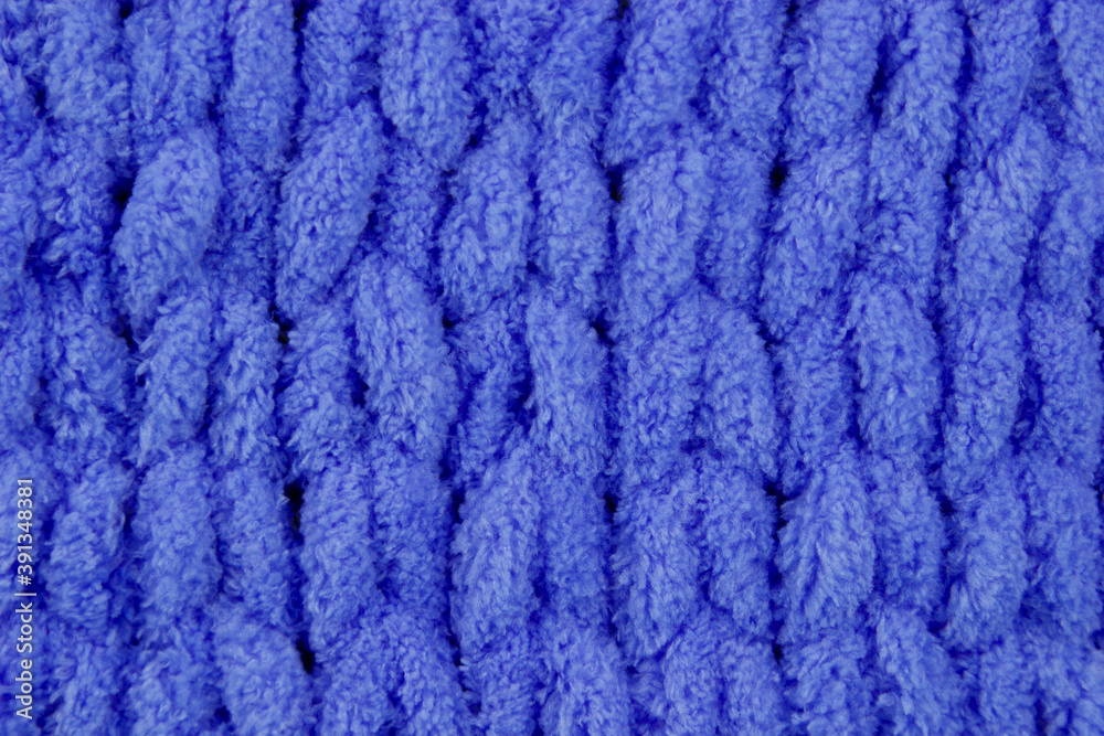 Close-up seamless knitted fabric of blue color, cozy winter knitted background. Unusual abstract texture background. Winter mood and cozy time at home Close-up seamless knitted fabric of blue color, cozy winter knitted background. Unusual abstract texture background. Winter mood and cozy time at home