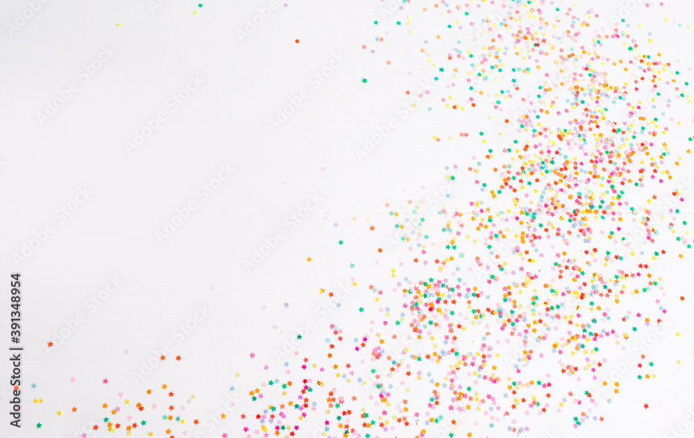 Lots of bright Christmas confetti on a white isolated background top view