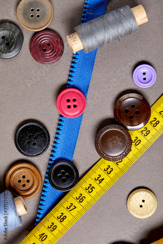 Background and texture of multicolored antique buttons and sewing tools