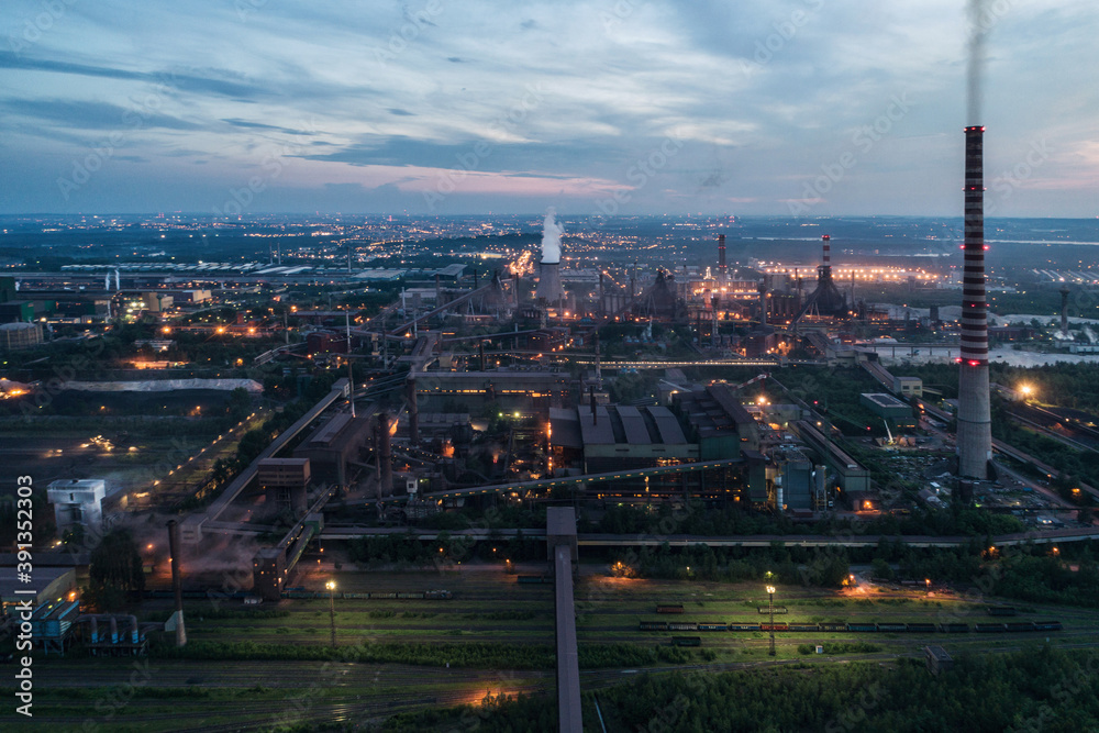 Obraz premium Industrial steel factory, iron works. Metallurgical plant. steelworks. Heavy industry in Europe, Poland, Dabrowa Gornicza. Air pollution from chimneys. Ecology and environmental. Aerial drone view
