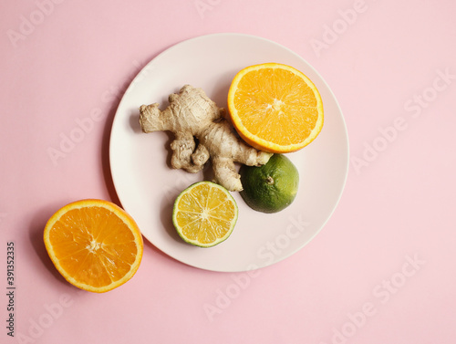 healthy citrus and ginger on pink bakcground photo