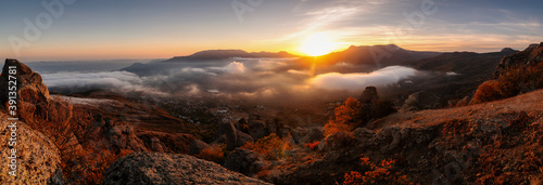 Sunset in the mountains in foggy weather