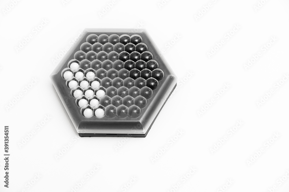 board game top view on a white background, a game for young people, black and white elements of the game, educational game,game abalone board game top view on a white background, a game for young people, black and white elements of the game, educational game,game abalone