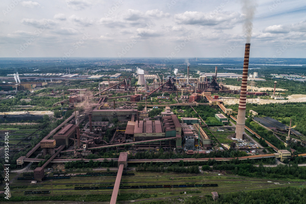 Obraz premium Industrial steel factory, iron works. Metallurgical plant. steelworks. Heavy industry in Europe, Poland, Dabrowa Gornicza. Air pollution from chimneys. Ecology and environmental. Aerial drone view