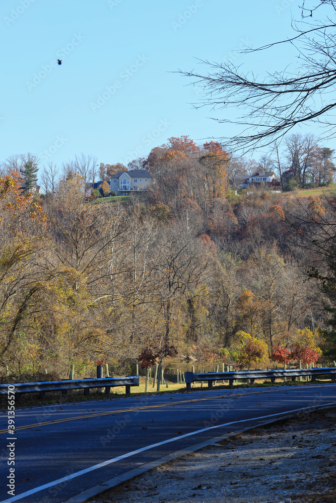 Empty road  with houses on a hill in Loch Raven Baltimore Maryland USA