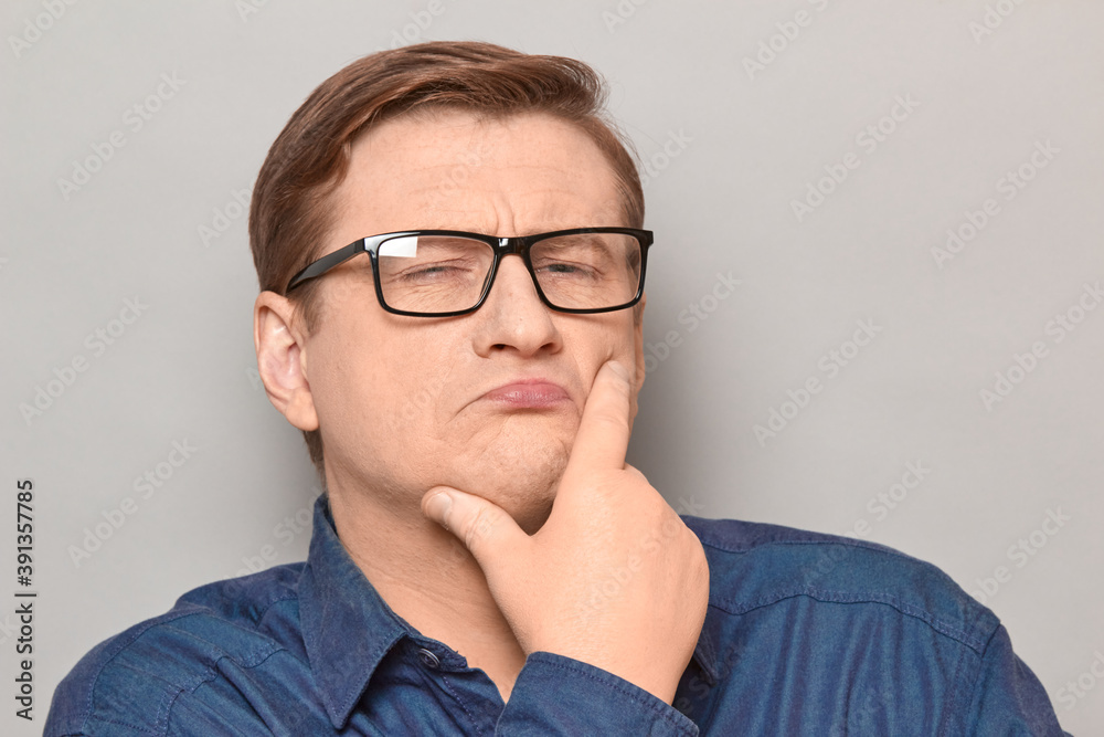 Portrait of funny thoughtful blond mature man with glasses Portrait of funny thoughtful blond mature man with glasses