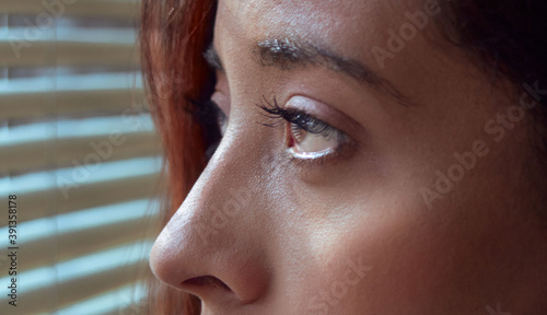 Canvas Print young girl looking out the window in retrospect