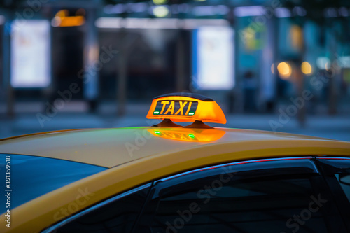 illuminated sign taxi on the roof of the car